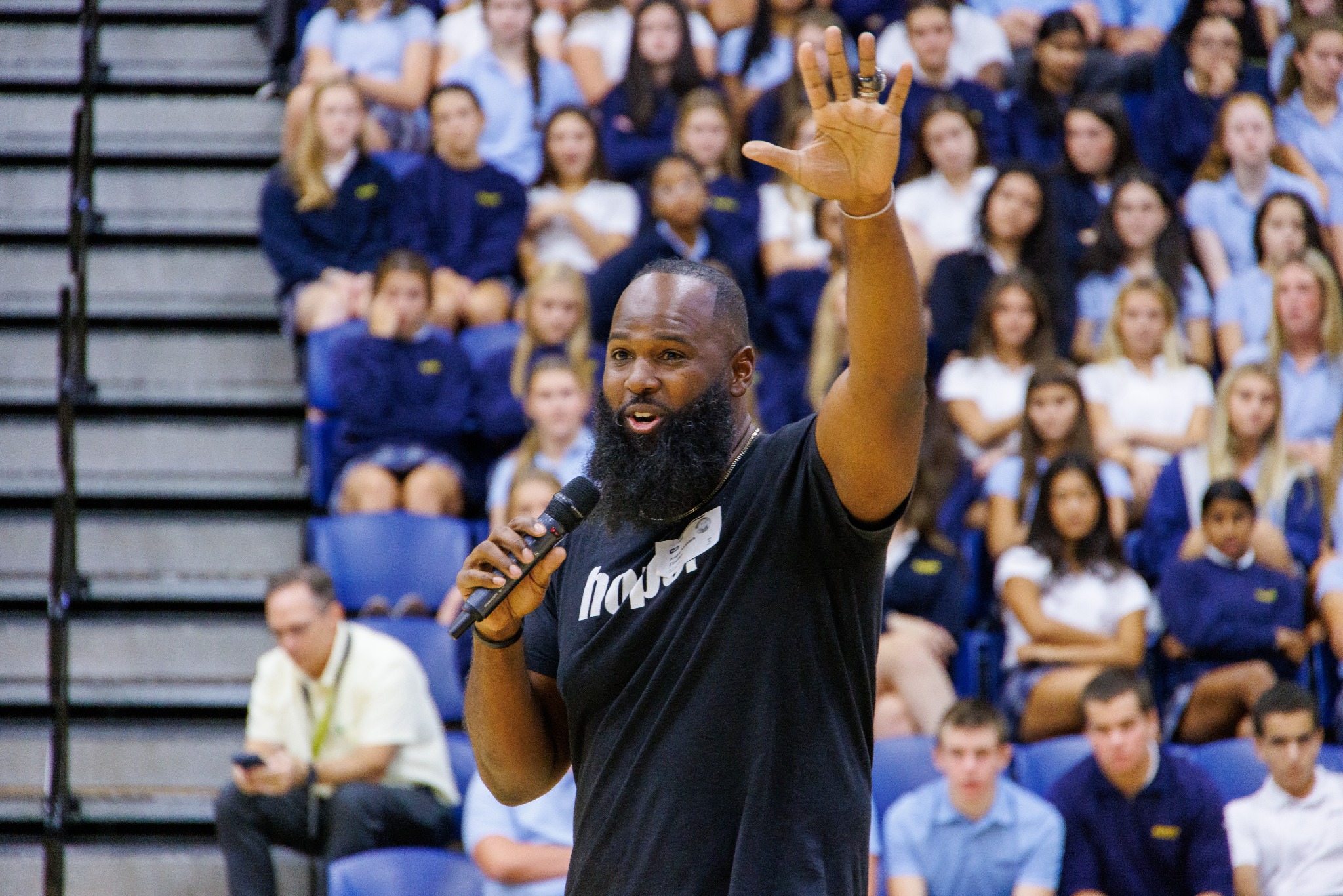 Andre Fluellen raising his hand while speaking with students