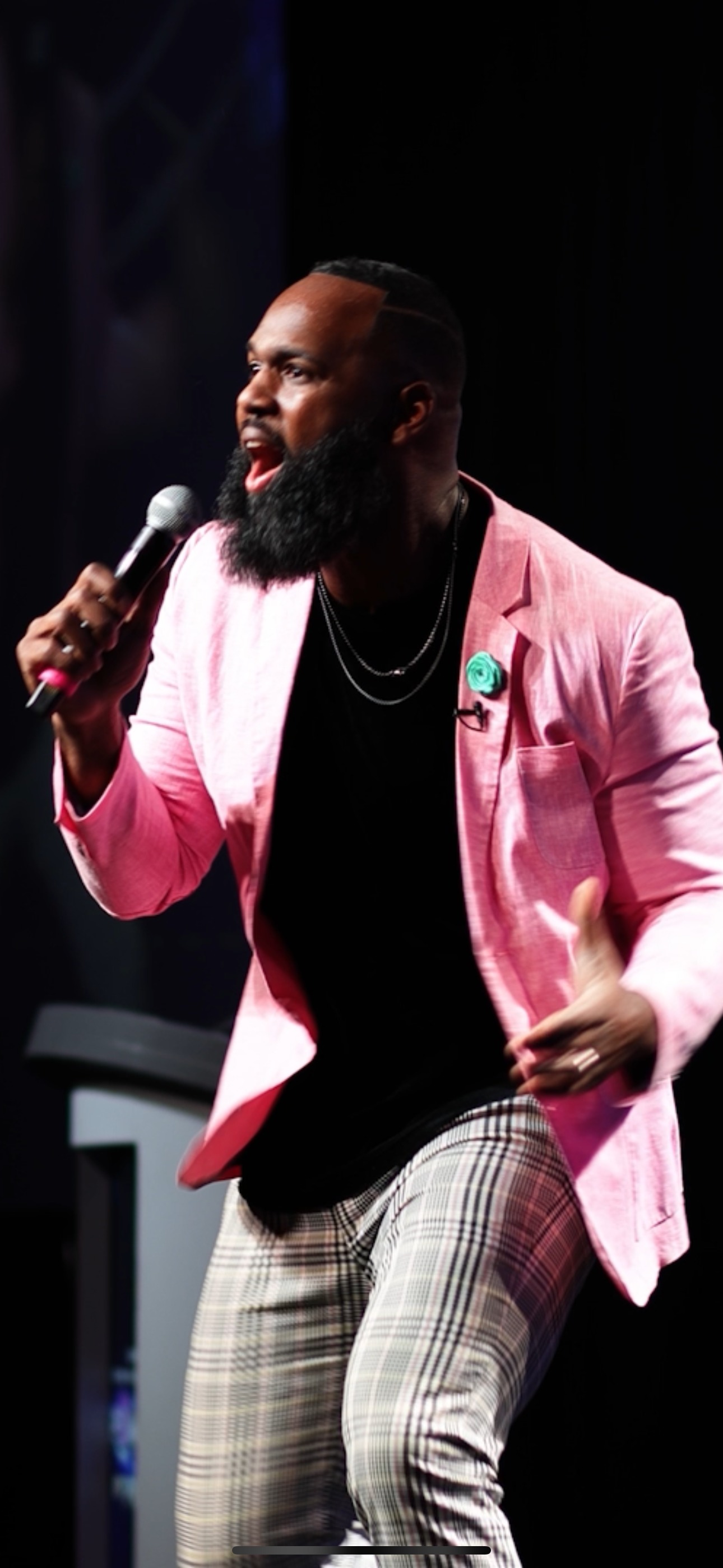 Andre Fluellen speaking on stage with microphone