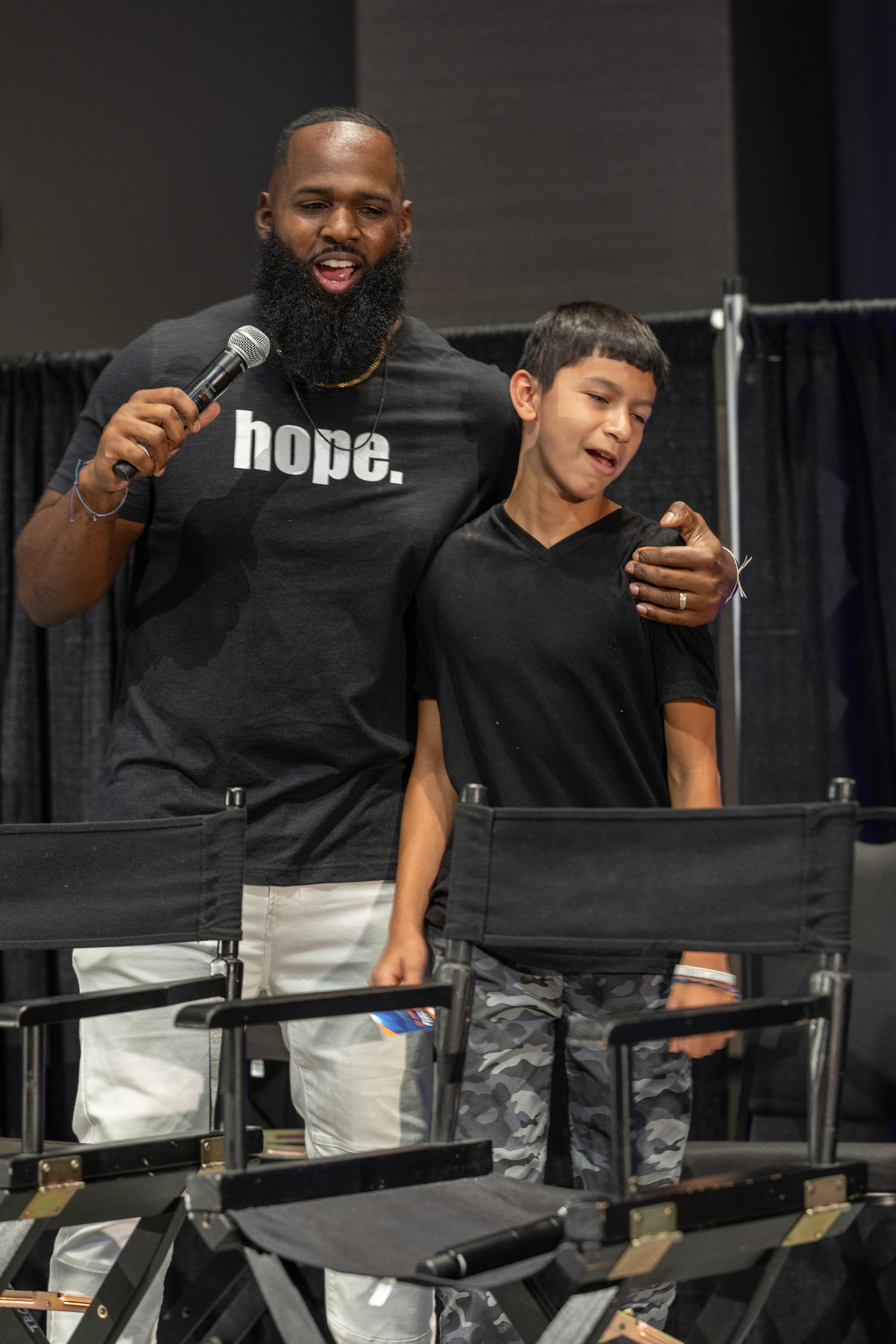 Andre Fluellen speaking beside a student