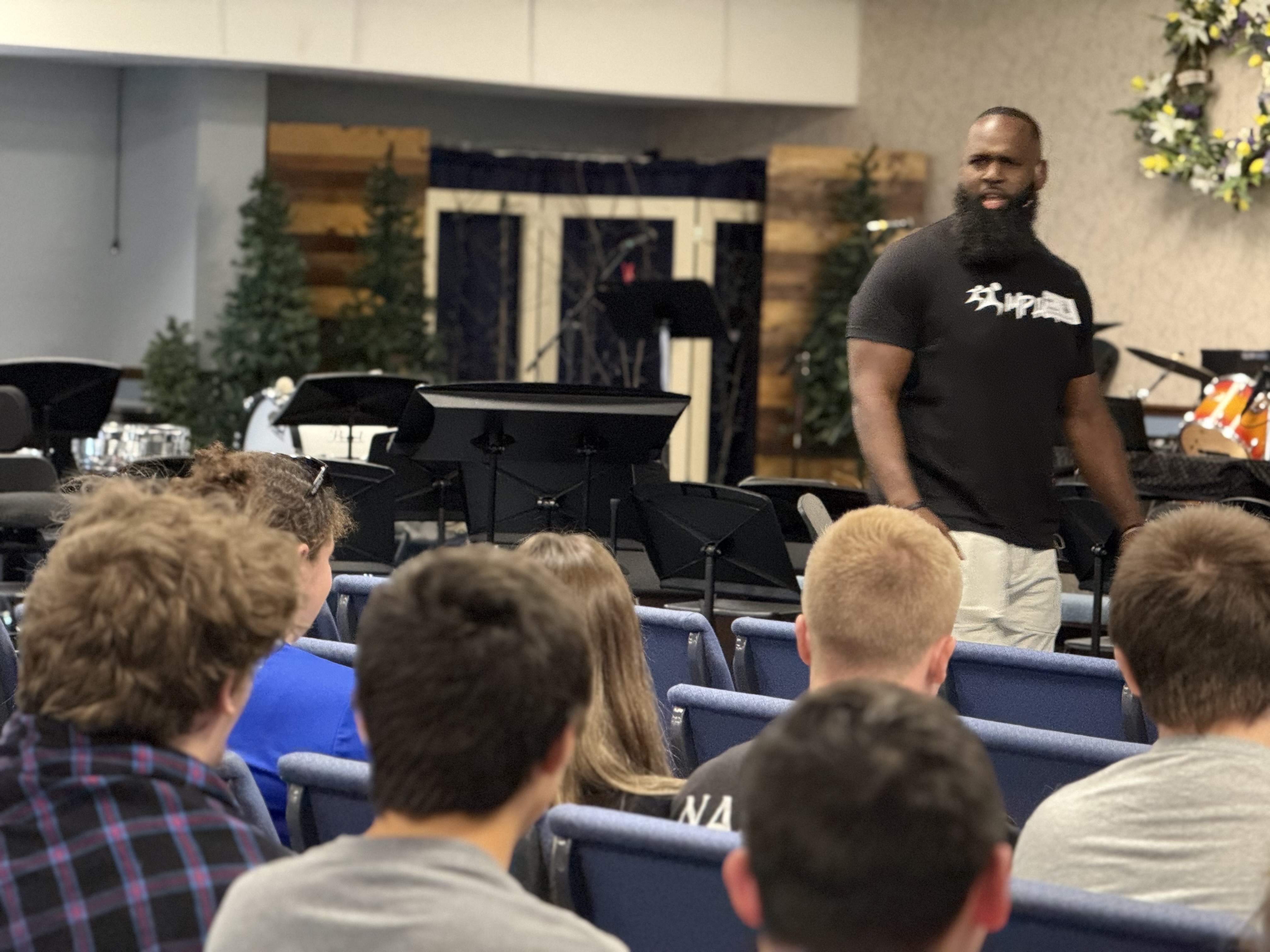 Andre speaking to attentive students in an auditorium